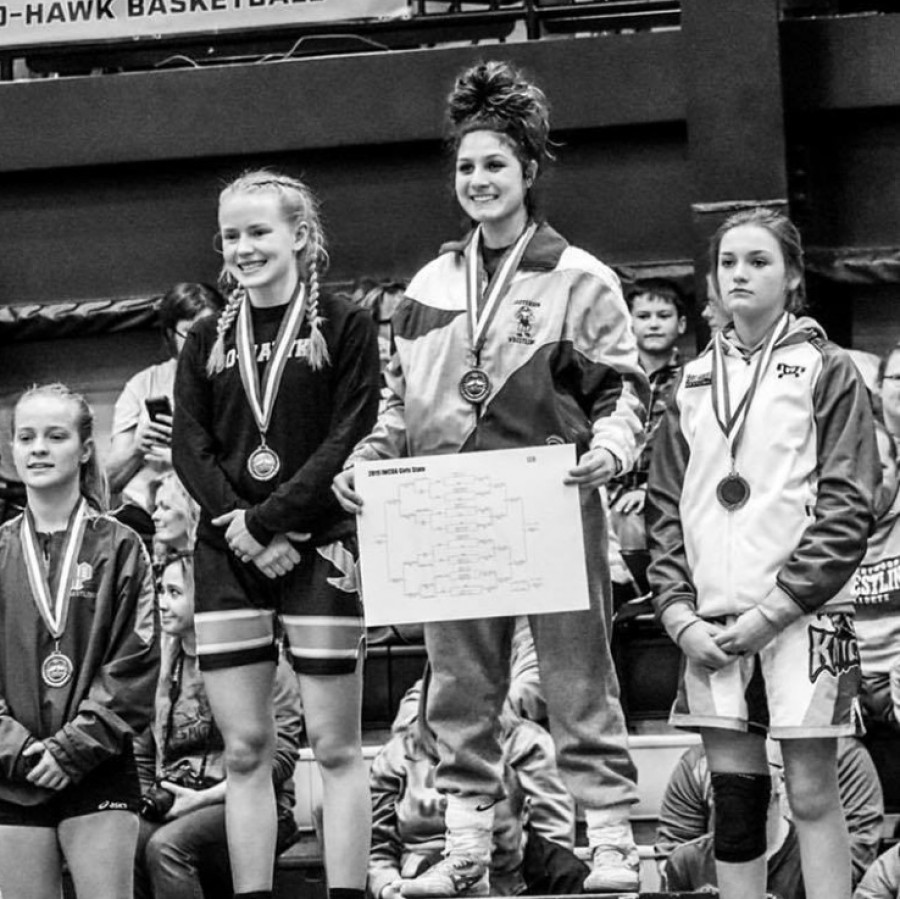 Chloe+Clemons+stands+atop+the+podium+as+champion+at+the+first+Iowa+girls+state+wrestling+tournament+in+Waverly%2C+Iowa+on+January+19%2C+2019.