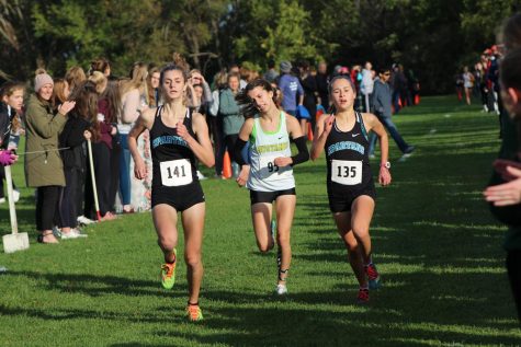 Freshman varsity runners, Gretchen Highberger and Lydia Sommer, battle through the last 200 meters of the district meet’s course at Crow Creek on October 24th. 