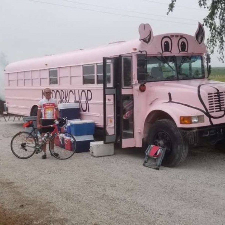 Nick Kamp stops at the Mr. Porkchop Bus during RAGBRAI, the famous bike ride across Iowa.