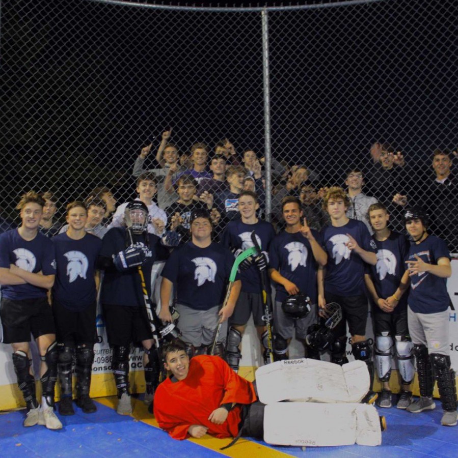 The+Spartans+Dek+Hockey+team+celebrate+with+their+student+section+after+their+final+regular+season+win.