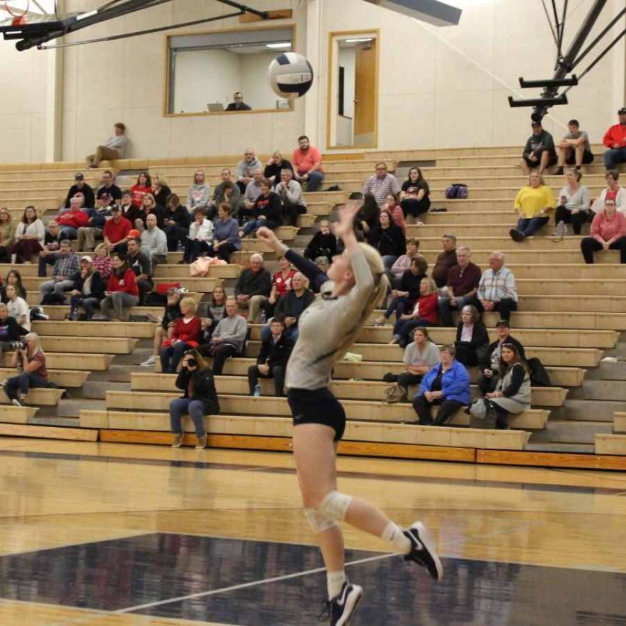 Emily Wood leaps up to serve the ball against the Knights.