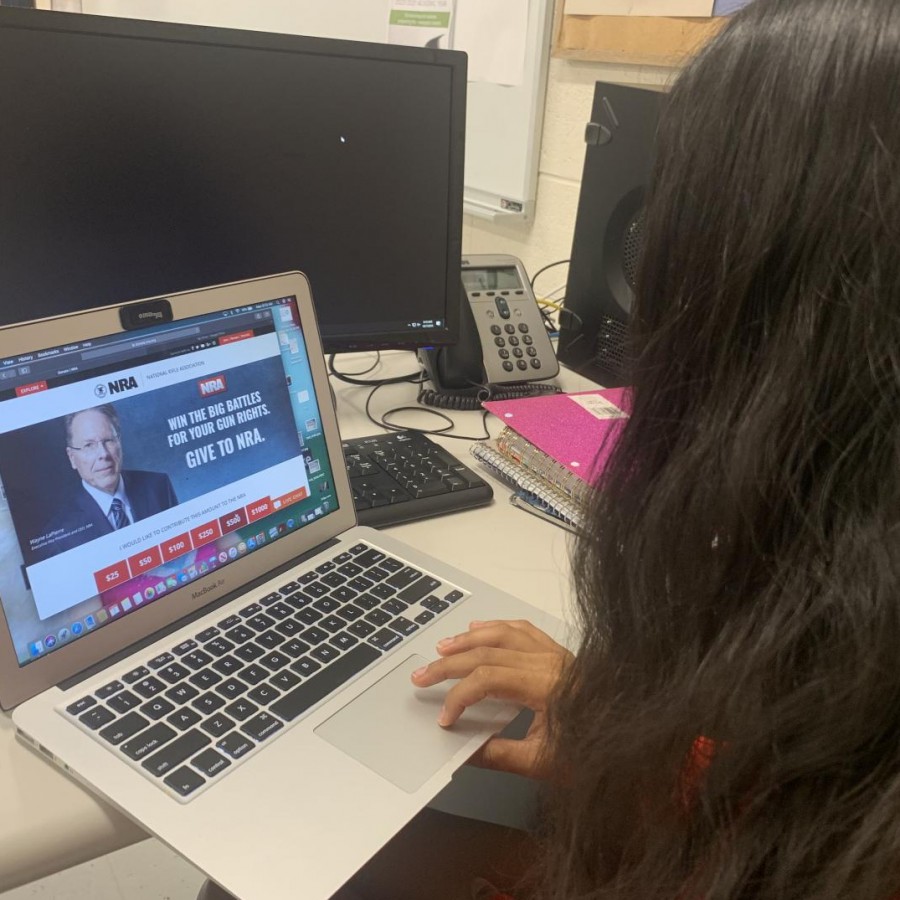 Senior Sakshi Lawande looking at the NRA donor website featuring CEO LaPierre.