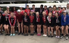 The team poses with their medals at the end of the regatta.