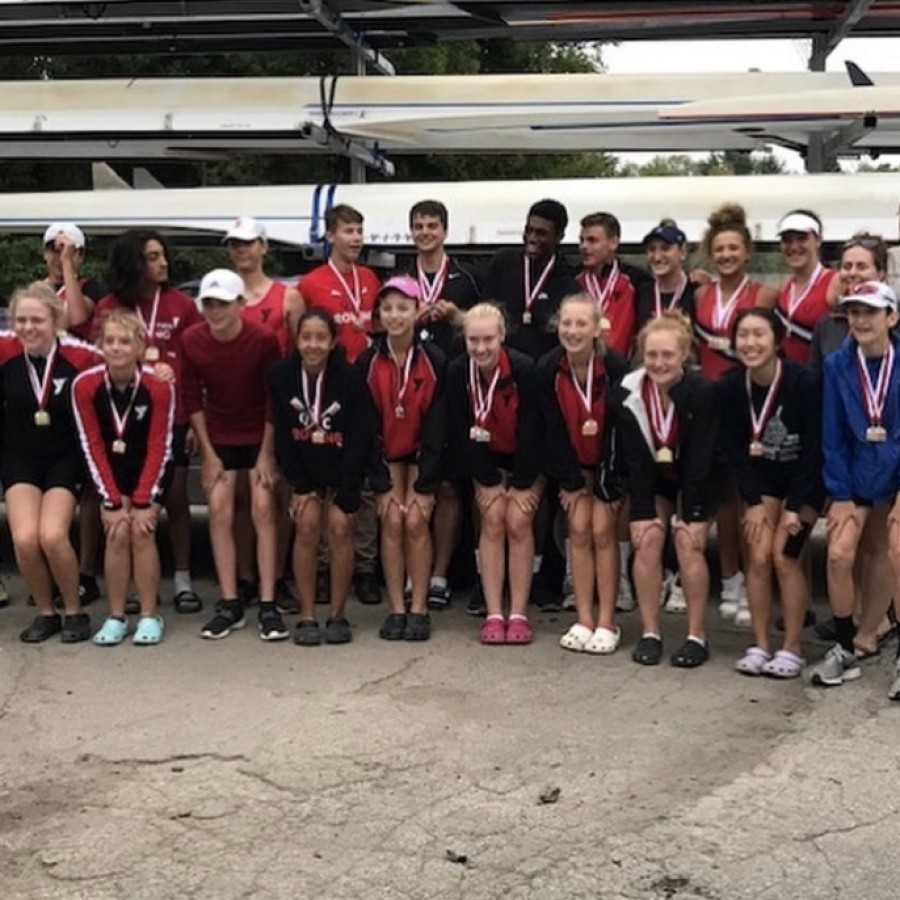 The team poses with their medals at the end of the regatta.