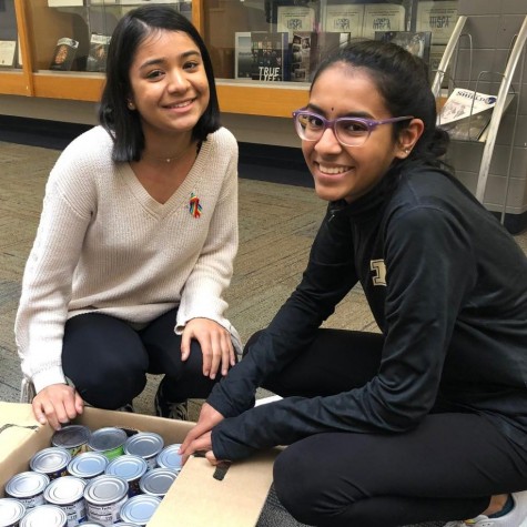 Spartan Assembly executives Muskan Basnet and Ramya Subramaniam counting cans to donate to the River Bend Food Bank.