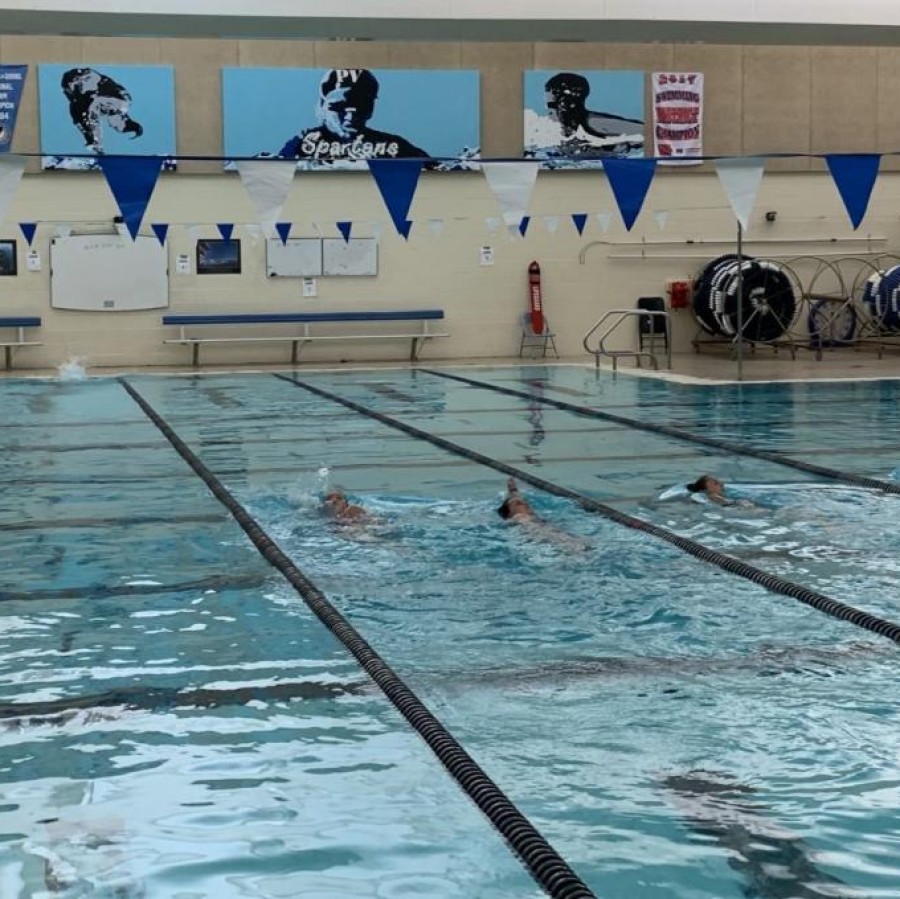 Softball pitchers and catchers complete a swim workout during the winter off-season to improve physical and mental strength.