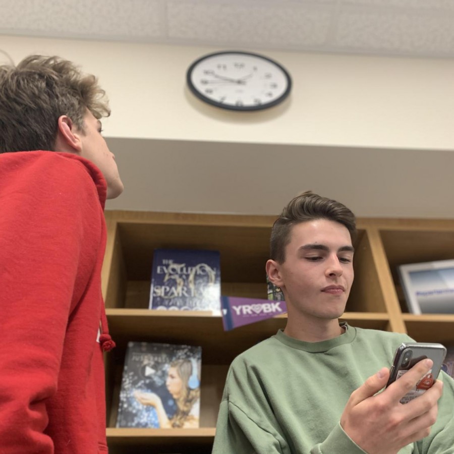 Seniors Jackson Schou (right) and Jack Donahue (left) look at the time, waiting for class to end without the bell.