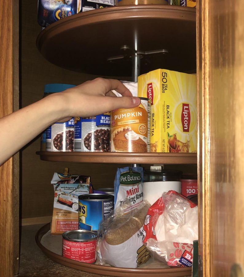 Student reaches into the cupboard to to get an important ingredient for fan favorite number 5.