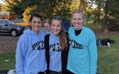 Senior Clare Basala stands amongst her female cross country coaches who have taught her about self-acceptance in the sport of running.