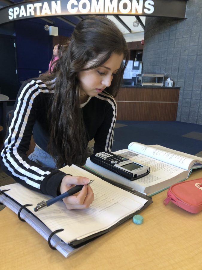 Senior Marali Sanchez works on homework during study hall in a U.S. educational environment.
