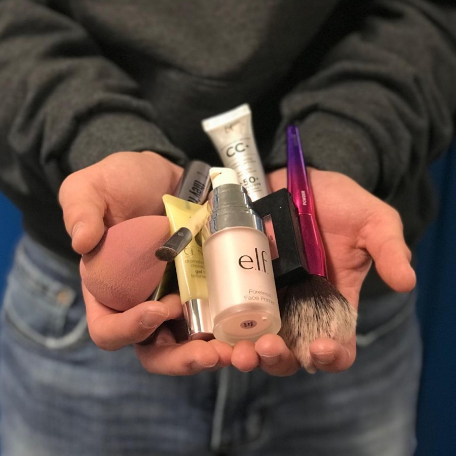 Senior Nick Kamp holds his everyday makeup products, including primer, concealer, and mascara.