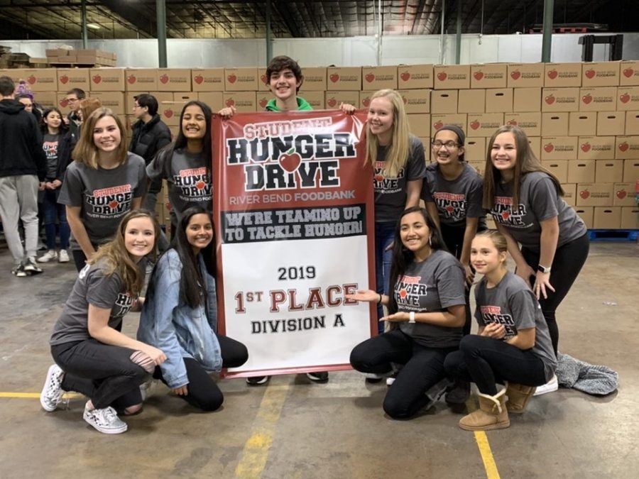 Spartan Assembly members show off their banner at the River Bend Foodbank after being awarded 1st place in the 2019 Division A Student Hunger Drive. 
