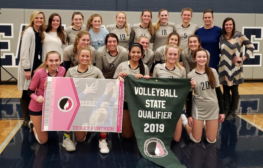 The+girls+volleyball+team+holds+their+banner+after+qualifying+for+state+for+the+first+time+in+six+years%2C+on+November+4%2C+2019.+