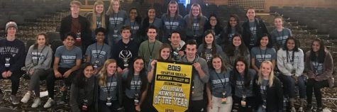 Shield and Valenian staff smile with their Iowa News Team of the Year banner at the Fall IHSPA conference on Oct. 24, 2019.