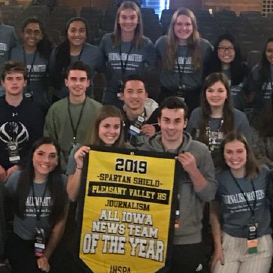 Shield and Valenian staff smile with their Iowa News Team of the Year banner at the Fall IHSPA conference on Oct. 24, 2019.