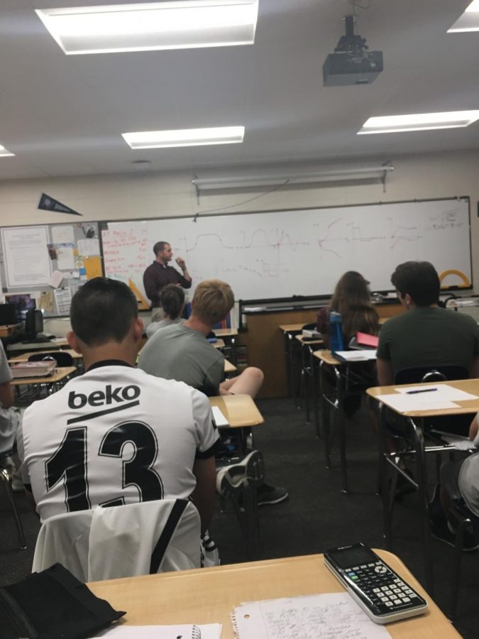 Mr. Spangenberg teaching AP Physics to his class a month before their AP test. 