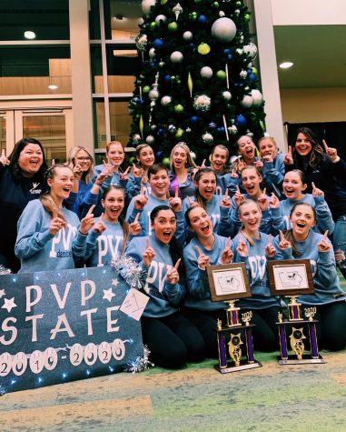 The state dance team is nothing but smiles as the members and coaches pose with their two first place trophies.