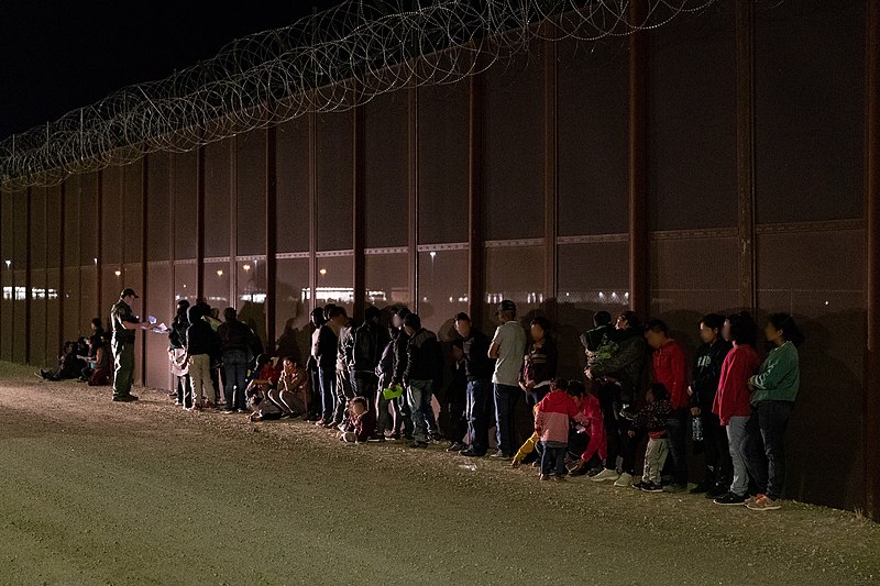 People suspected to have immigrated illegally are gathered by the Arizona border.