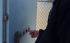 Senior Anthony Cox pushes a button to turn on the tennis court lights on his desired court after paying a fee. 