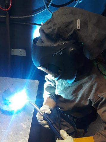 Megan Fee shows her welding expertise while working at John Deere Davenport Works, Iowa on December 5, 2018.