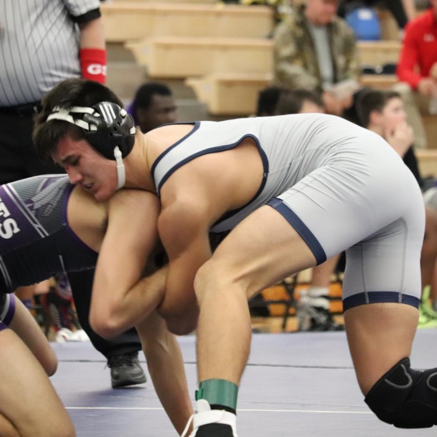 TJ Brown attempts to pin a Muscatine wrestler in a meet.