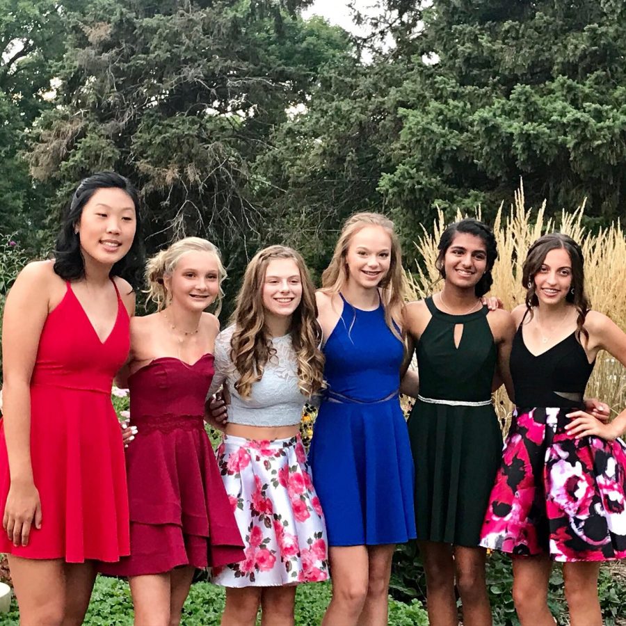 : Katie Larsen (blue dress) poses with her friends for her first homecoming.
