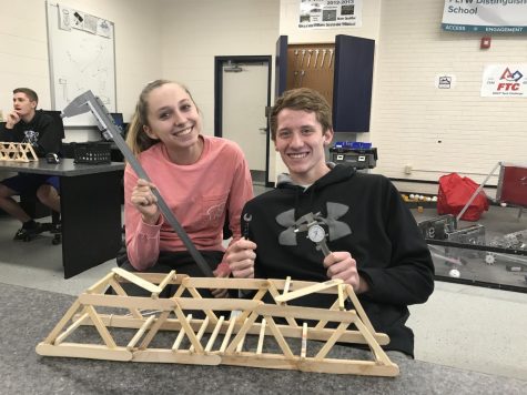 Seniors Sara Hoskins and Peyton Weisbeck pose for a photo with their submission for the Bridge Building Contest in the high school engineering room. The contest was held in March 2019.