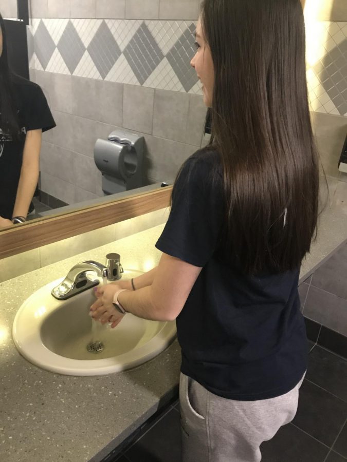 Senior Morgan Ramirez washes her hands to protect against the flu.