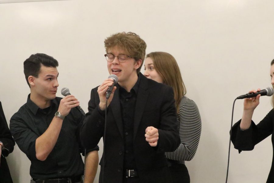 Senior John Mendelin singing his solo in the jazz song “Café” at a rehearsal for Leading Tones. 