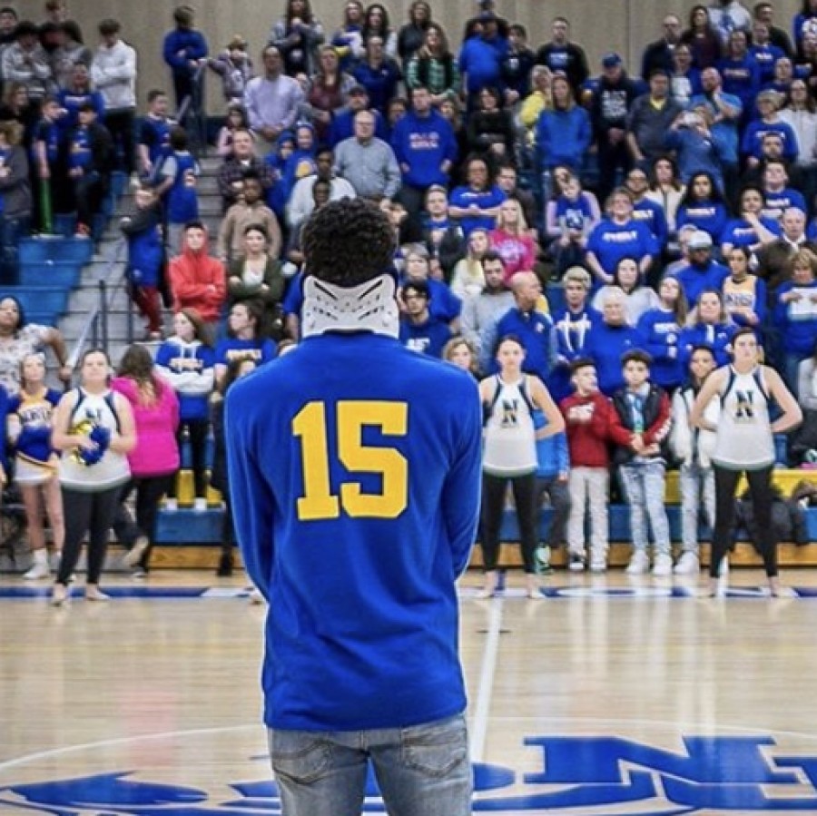 Jamal+Litt%2C+Davenport+North+varsity+basketball+player%2C+attends+basketball+game+against+Pleasant+Valley%2C+where+both+student+sections+dressed+in+his+favorite+color+in+support+of+him+and+his+accident.+%0A