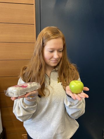 Senior Kelsey Murphy, deciding whether she wants to take the healthier or the less healthier path when choosing her snack in the PVHS Commons during study hall.