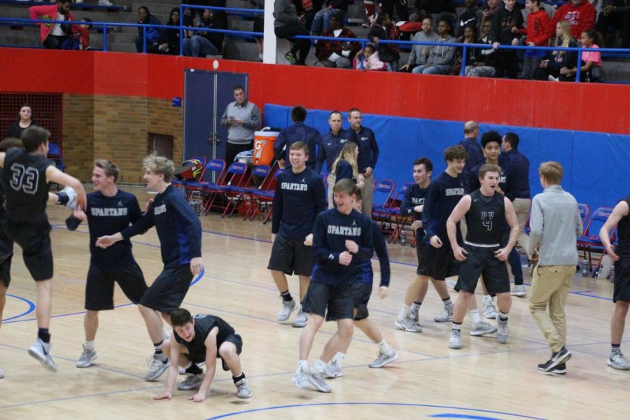 The Pleasant Valley boys basketball team celebrates their victory over Davenport Central.