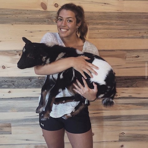 Senior Natalie Adams tries goat yoga for the first time.