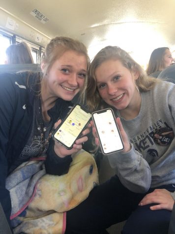 Juniors Jessi Meyer and Isabel Russman show their tracking apps.