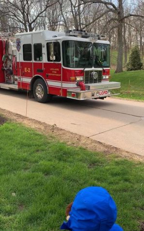 Morgan Turner’s son watching his birthday parade that’s full of firefighters, his daycare teachers and members of the LeClaire community.