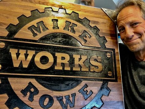 Mike Rowe poses in front of his foundation’s logo as they near their 10th anniversary.