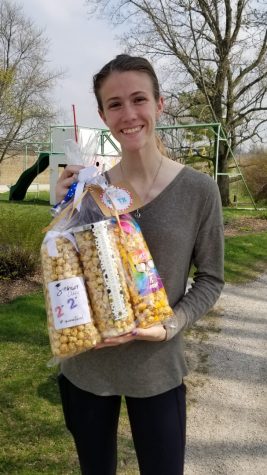 Senior Katie Garner holds a basket of popcorn that she received from a parent through the “Adopt a Senior” Facebook page. 