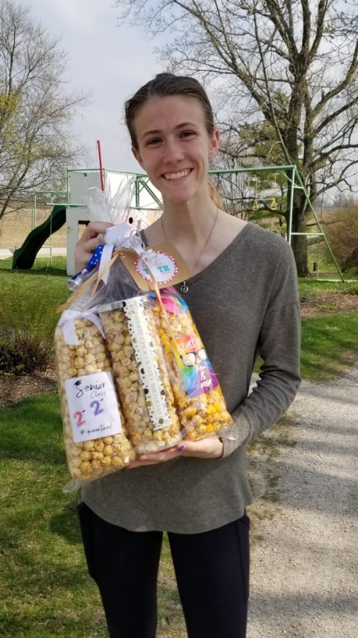 Senior+Katie+Garner+holds+a+basket+of+popcorn+that+she+received+from+a+parent+through+the+%E2%80%9CAdopt+a+Senior%E2%80%9D+Facebook+page.+