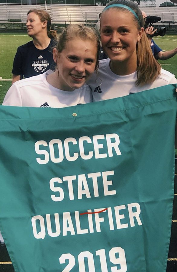 Senior Ellie Scranton and Junior Isabel Russmann pose for a picture after winning their soccer regional final game in 2019.