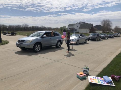 Senior Grace Halupnik receives a birthday car parade set up by her friends on her special day.