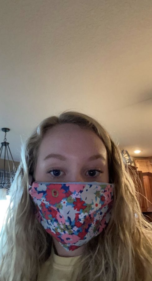 Sophomore Sidney Brockmann poses in a mask she made at home.