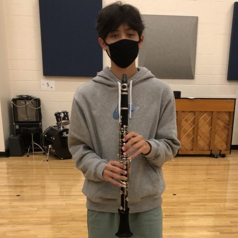 Marching during a “Bandemic”-  Junior Gavin Pangan plays his clarinet during a socially-distanced rehearsal.
