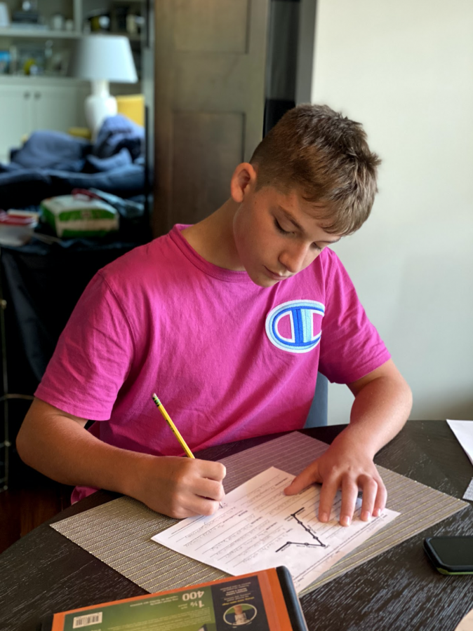 Alex Van Utrecht works on school work during his at home day.