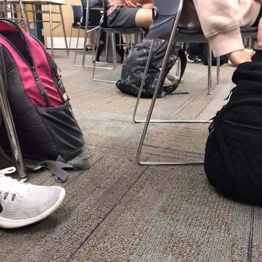 Multiple backpacks are present on the floor next to students’ desks in English teacher, Maureen Dyer’s honors journalism class. Backpacks are now present in classrooms due to COVID-19 and the lack of locker usage in the school.