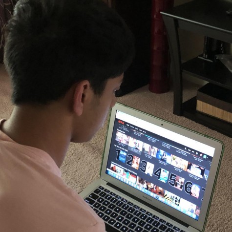 Senior Akash Pradeep scrolls through the Netflix home screen in search of his favorite show, “The Office.” This is one of the reasons that many viewers, like Pradeep, remain loyal to the monopolizing streaming service.