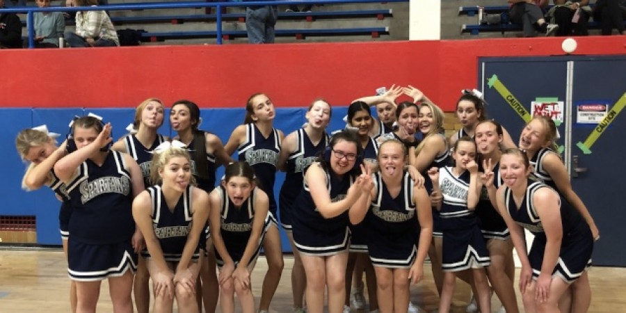 The Sparkles cheerleading team gathers for a picture before their halftime performance at Hoops for Hope at Davenport Central High School in September, 2019.