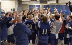The Pleasant Valley football team celebrates in the locker room after beating Iowa City West on Nov. 6.