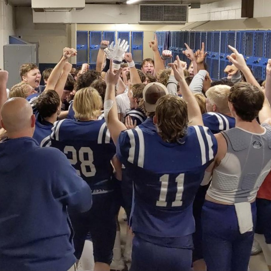 The Pleasant Valley football team celebrates in the locker room after beating Iowa City West on Nov. 6.