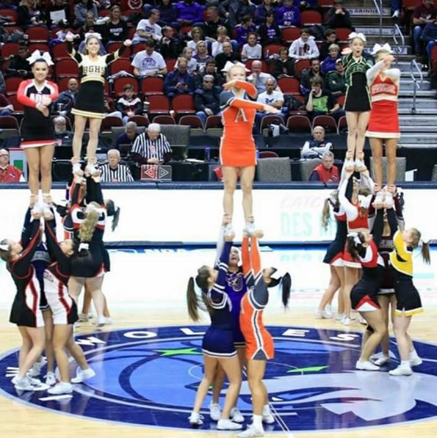 The 2018 Iowa All-State cheerleaders stunt during their performance for the boys basketball state tournament.