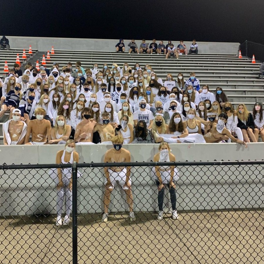Pleasant Valley Spartan fans stand close together at the Brady game on Oct. 8. While they are wearing masks, they fail to stand 6-feet apart, putting themselves at risk for infection.